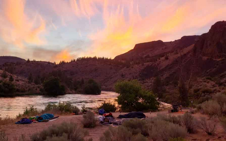 girls camp at sunset on rafting expedition with outward bound